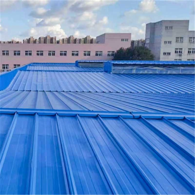 Blue clip-lock metal roof panels installed on a commercial building
